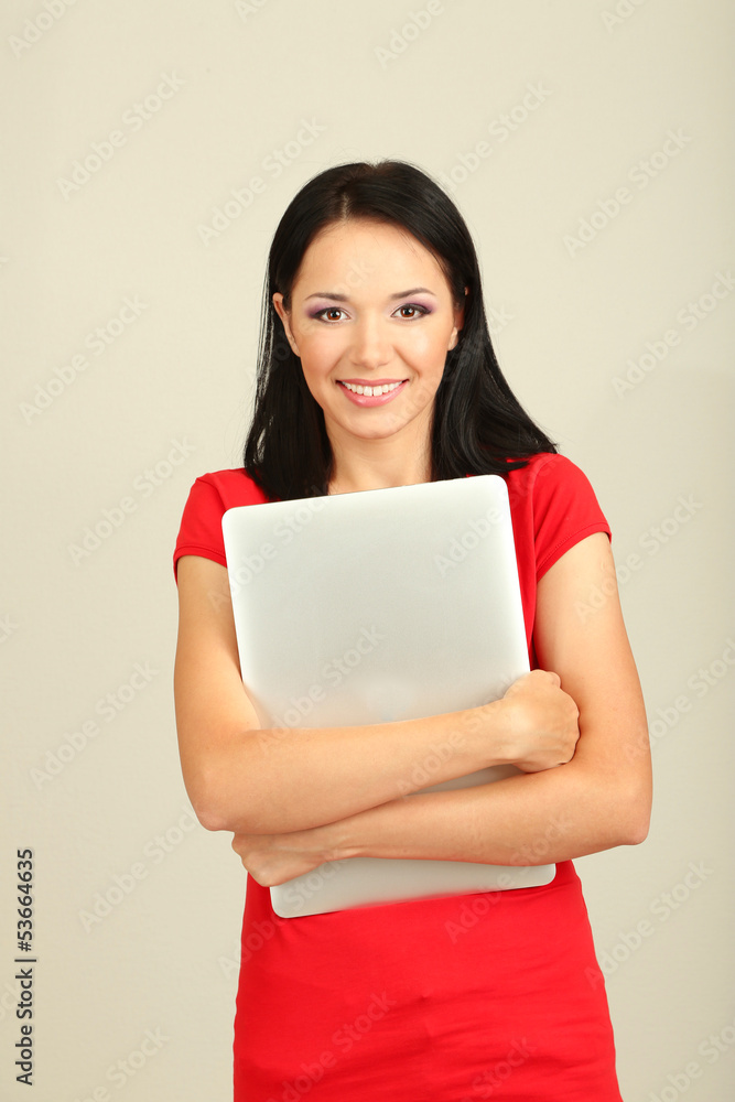 Beautiful young woman with notebook in room Beautiful young woman with notebook in room
