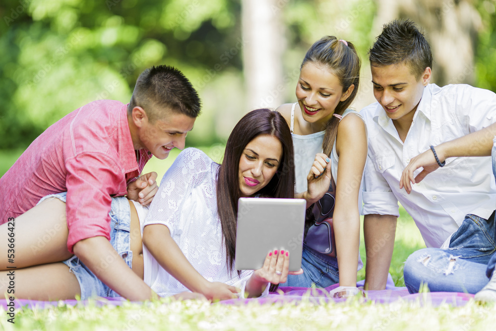 Teenagers in the park with tablet Teenagers in the park with tablet