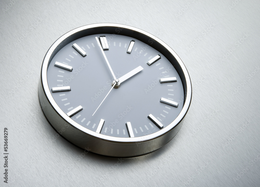 Metal clock on the wall of steel Metal clock on the wall of steel