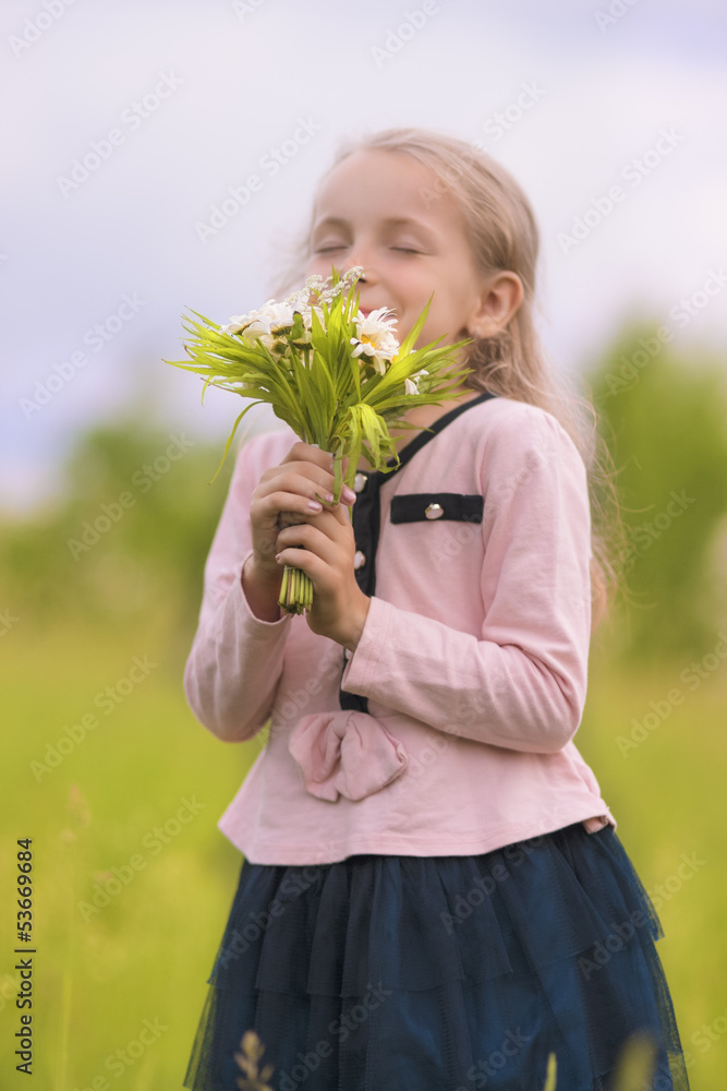 portrait of young little girl smelling flowers portrait of young little girl smelling flowers