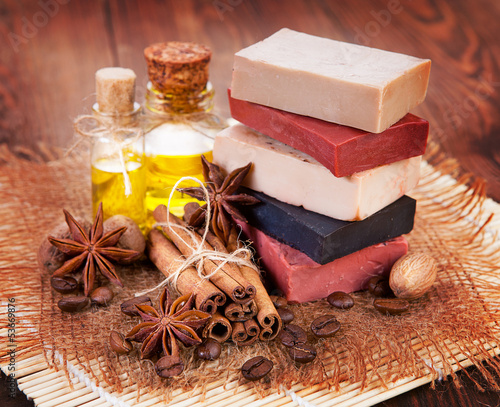 Handmade soap, oil in bottles anise and cinnamon on the table