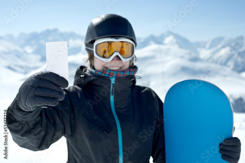 Snowboard girl with blank card smiling