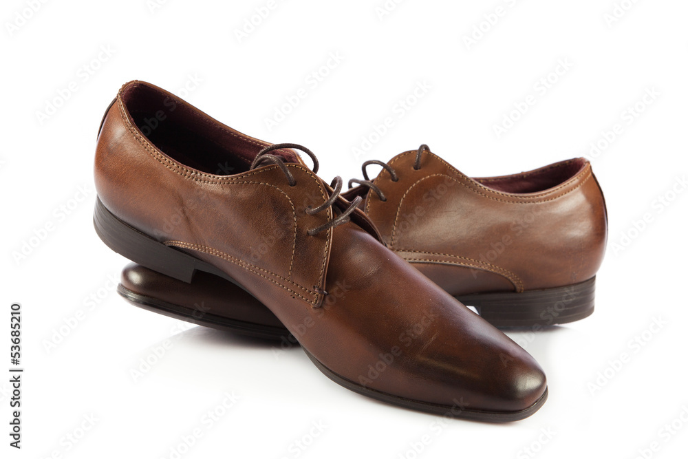 Brown man's shoes isolated on white background. Pair of brown m Brown man's shoes isolated on white background. Pair of brown m