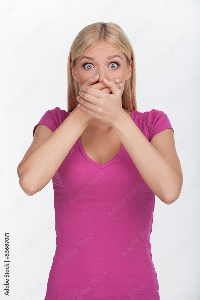 Shocked with the latest gossip. Beautiful young woman covering h Shocked with the latest gossip. Beautiful young woman covering h