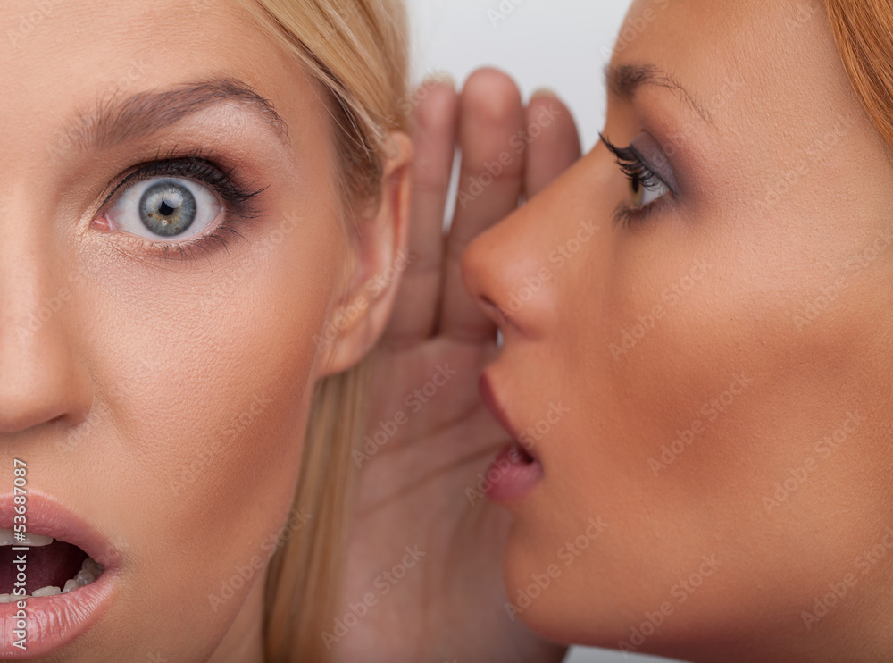 It is unbelievable! Close-up of two beautiful young women gossip It is unbelievable! Close-up of two beautiful young women gossip