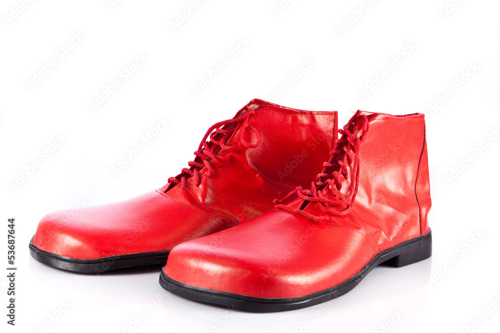 Very big red clown shoes on white