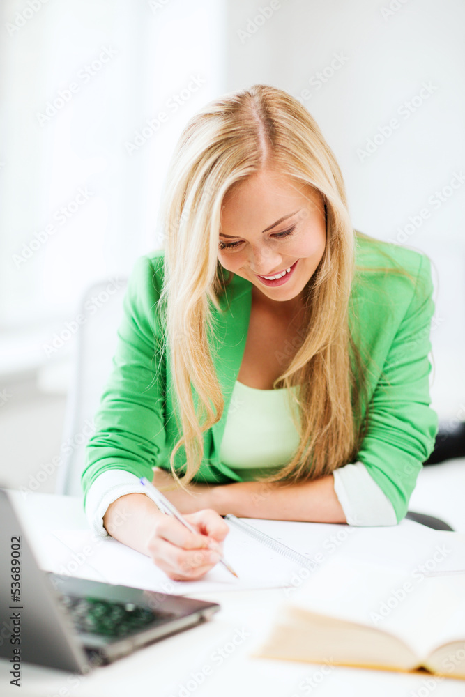 smiling student girl writing in notebook smiling student girl writing in notebook