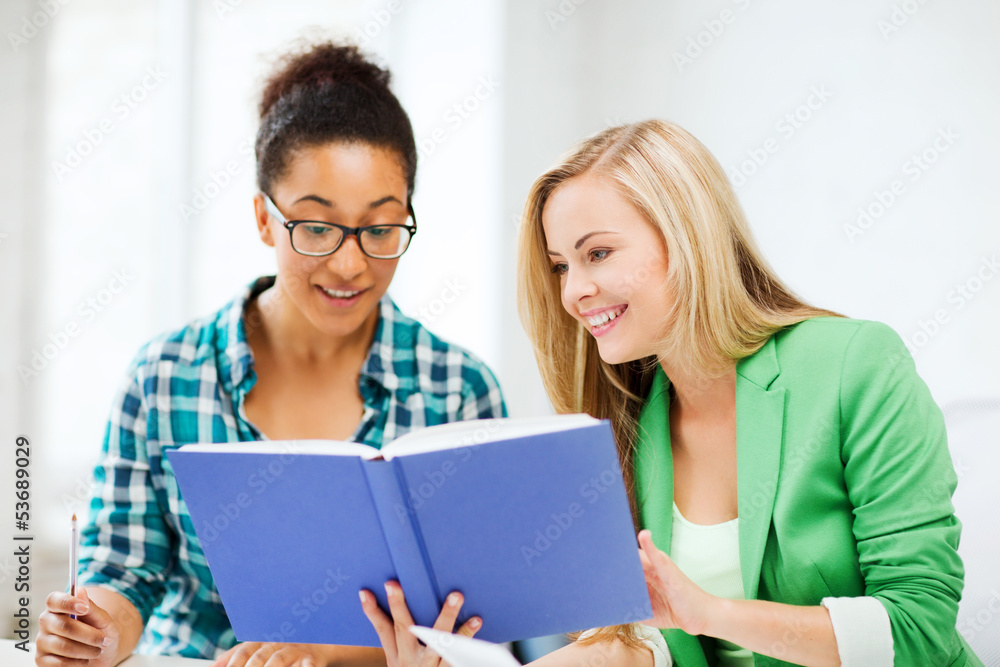 smiling student girls reading book at school smiling student girls reading book at school