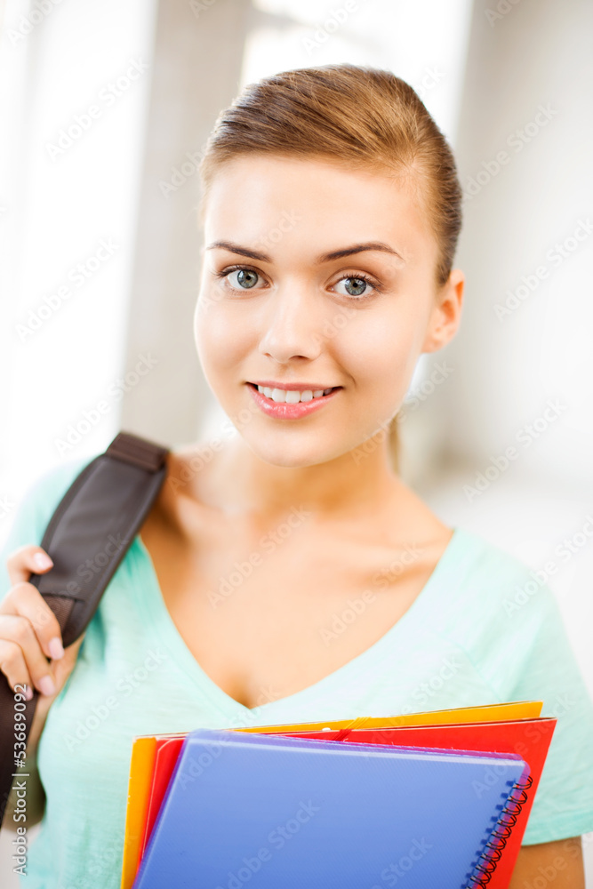 student girl with school bag and color folders student girl with school bag and color folders