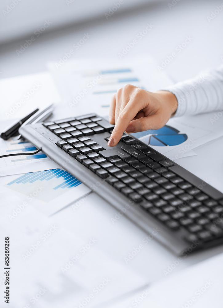 woman hand pressing enter button on keyboard woman hand pressing enter button on keyboard
