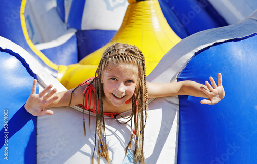 Delighted girl on inflatable attraction