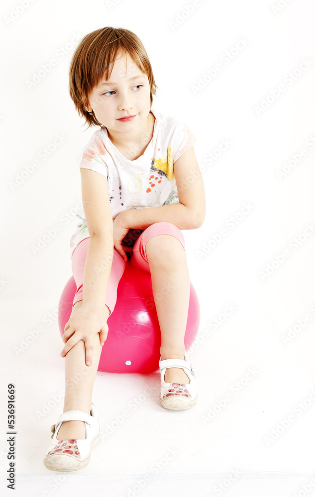 girl sitting on a ball girl sitting on a ball