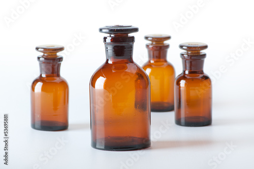 Small chemical glass bottles on white background