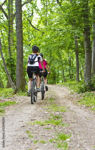 girls biking in the forest