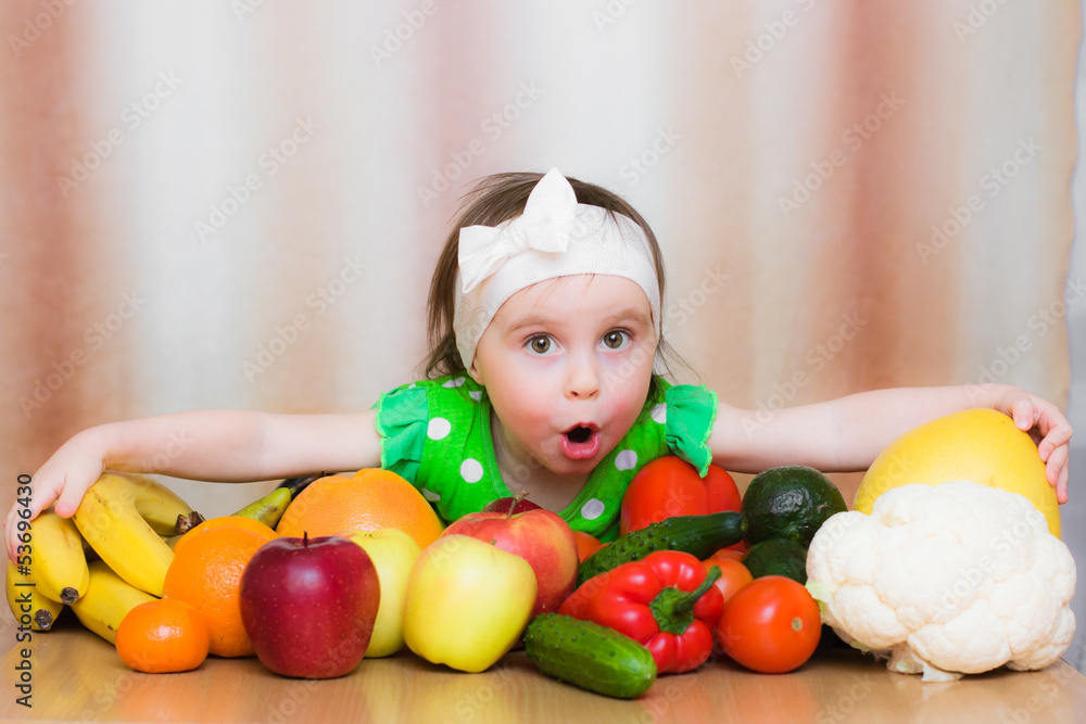 Fototapeta premium Happy Kid with vegetables and fruits.