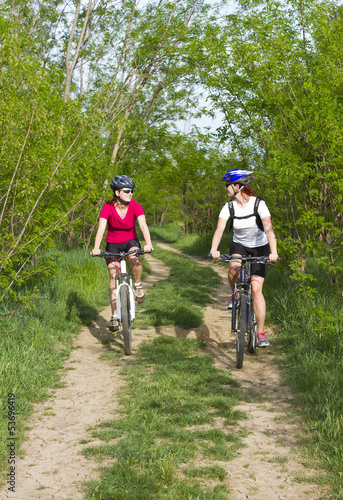 girls  biking in the forest © giorgiomtb