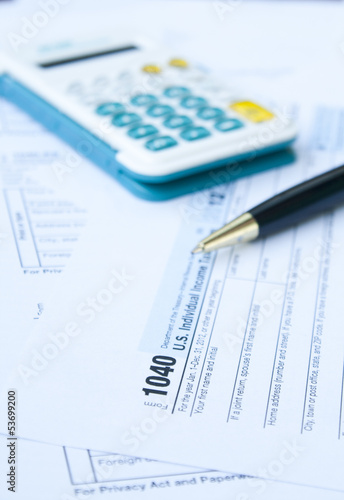 U.S. Tax form, pen and calculator