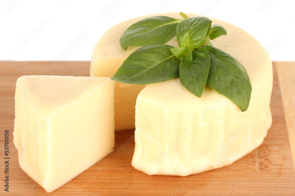Cheese mozzarella and basil on cutting board isolated on white Cheese mozzarella and basil on cutting board isolated on white
