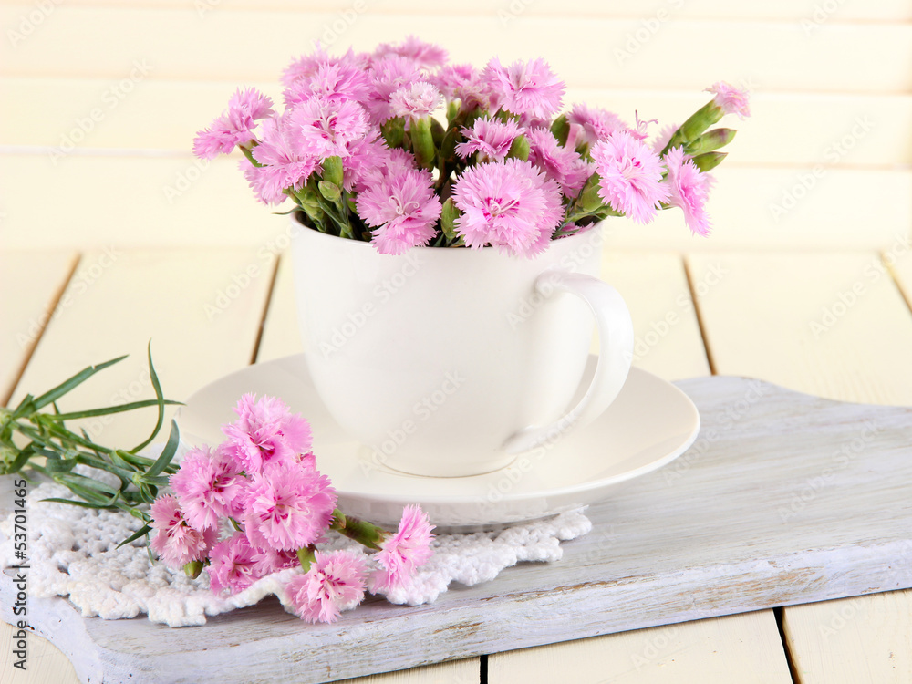 Many small pink cloves in cup Many small pink cloves in cup