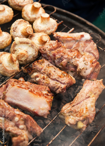 Barbecue with grilled meat on grill.