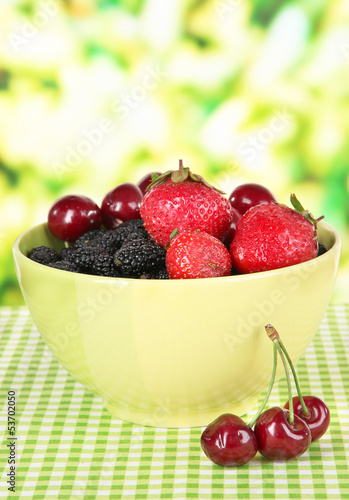 Ripe mulberries with cherry and strawberries in bowl