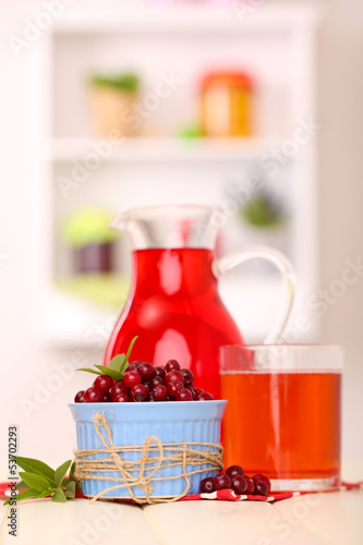 Pitcher and glass of cranberry juice with red cranberries