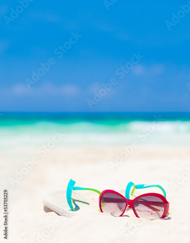 sun glasses and flip flops on a tropical Mexican beach