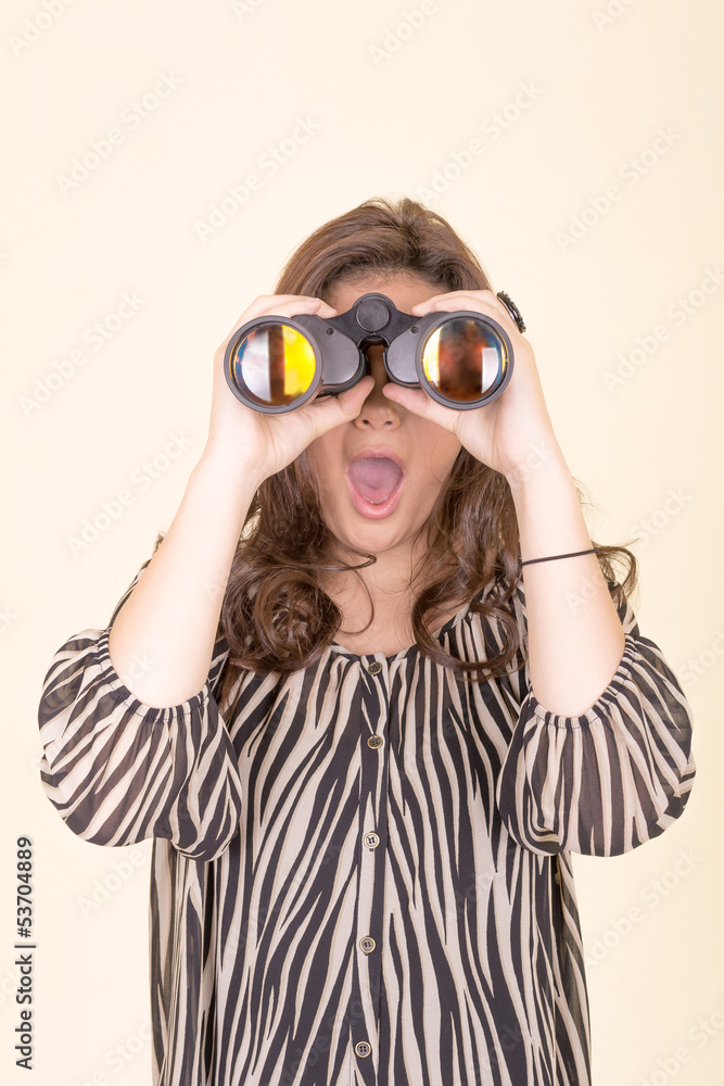 cute woman holding binoculars, yellow background cute woman holding binoculars, yellow background