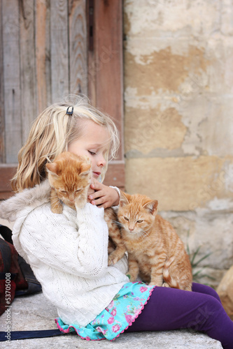 Girl with two kittens