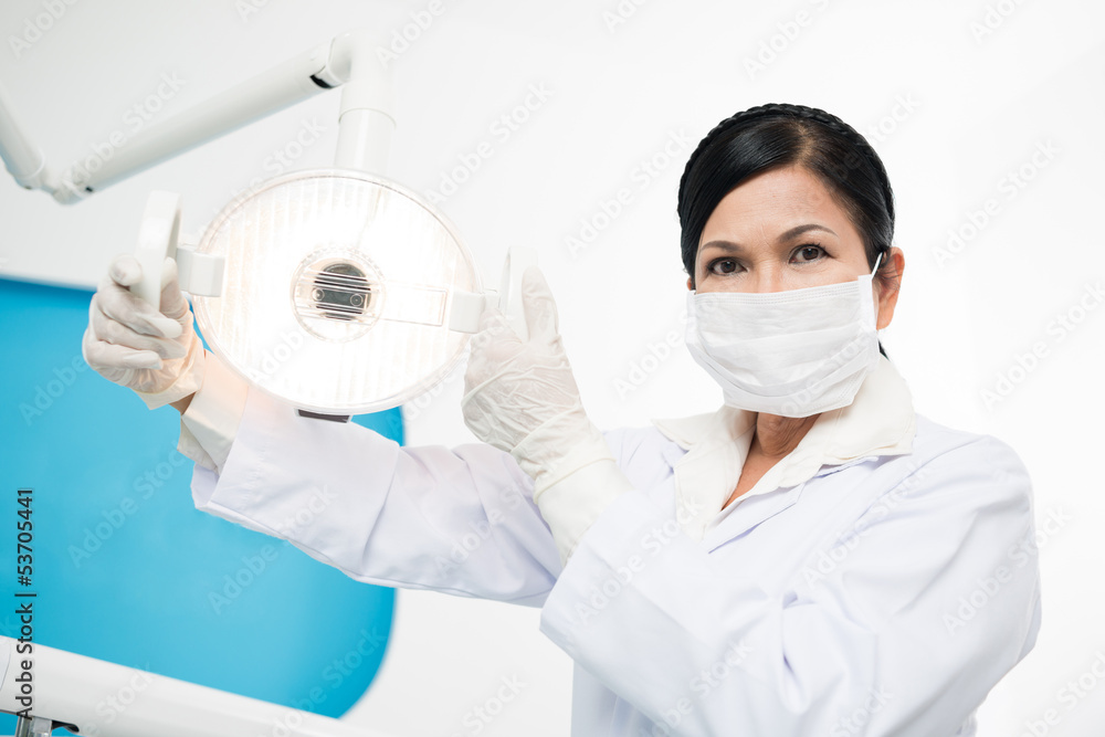 Naklejka premium Adjusting dental lamp