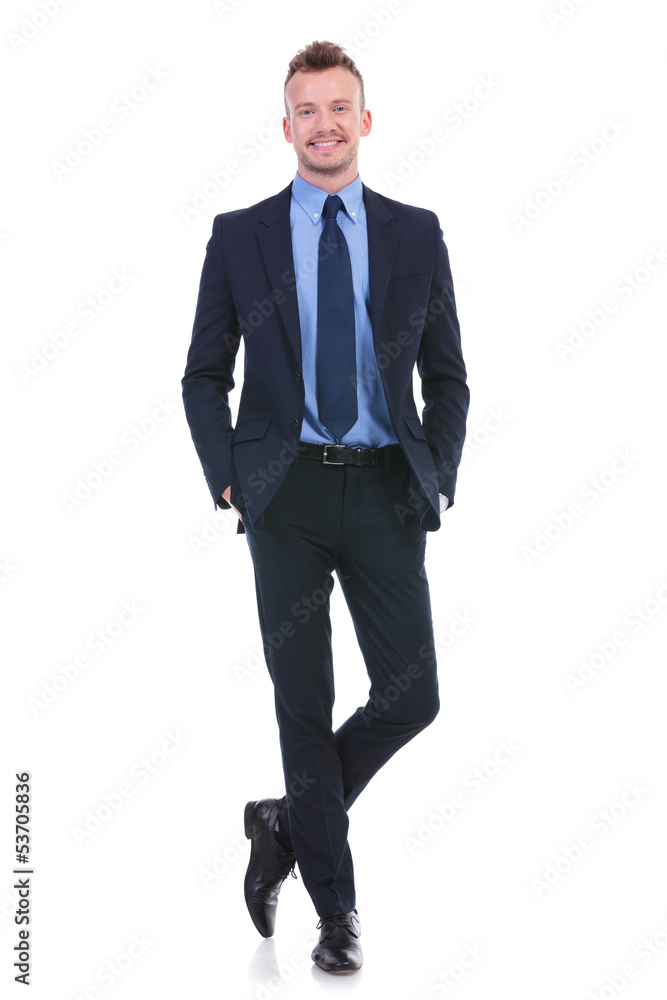 business man stands with both hands in pockets business man stands with both hands in pockets
