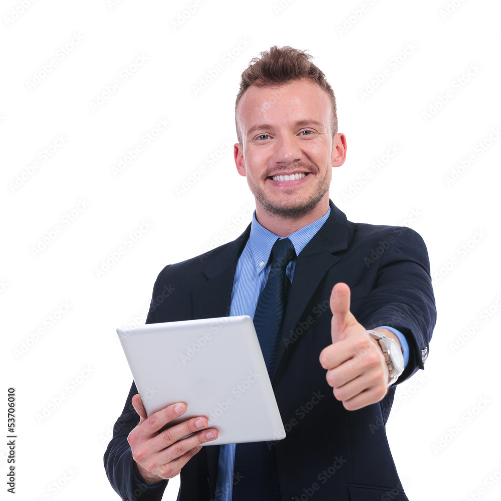 business man holds tablet and shows thumb up business man holds tablet and shows thumb up