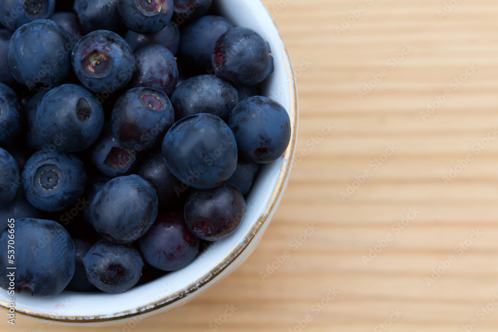 Blueberries in a bowl on a wooden table. Blueberries in a bowl on a wooden table.