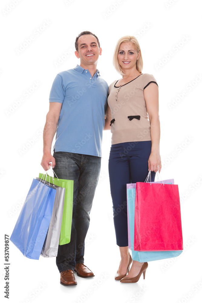 Portrait Of Young Couple Holding Shopping Bag Portrait Of Young Couple Holding Shopping Bag