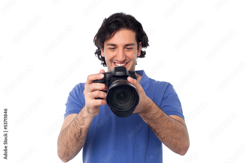 Man looking at pictures stored in camera Man looking at pictures stored in camera