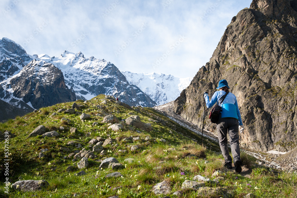 Fototapeta premium Hikier is climbing mountain in Caucasus mountains in Bezengi reg