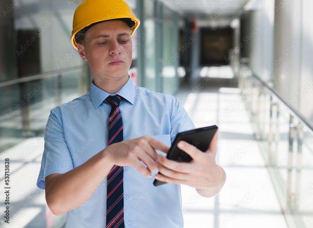 engineer in a helmet with a digital tablet engineer in a helmet with a digital tablet