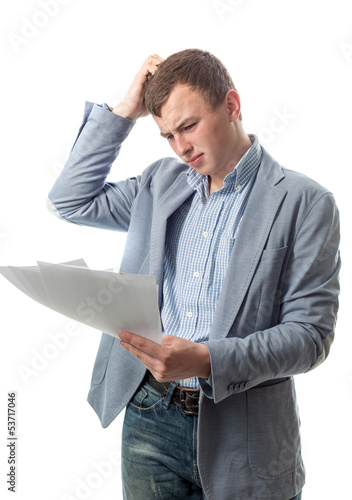The guy looks documents and scratches a head