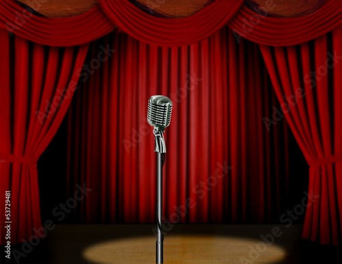 Retro microphone and red curtain on a stage with spotlight