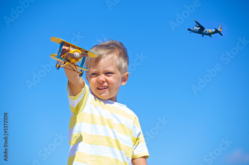 Boy playing with a toy airplane