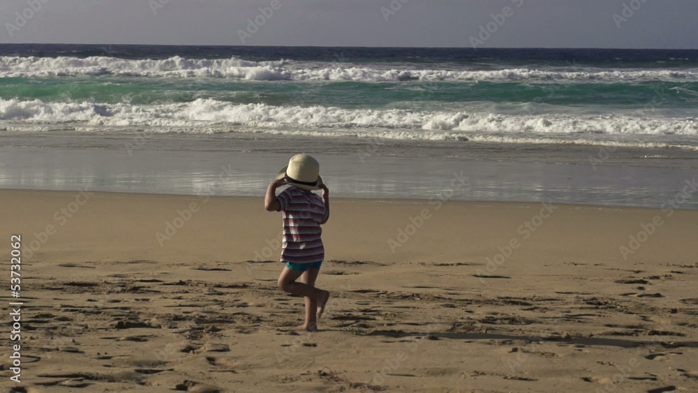 Little boy running on the beach, slow motion shot at 240fps Little boy running on the beach, slow motion shot at 240fps