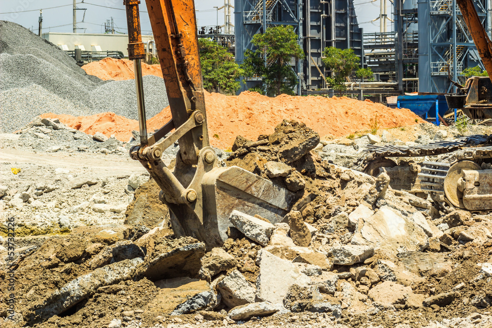 Fototapeta premium Excavator digging the concret floor