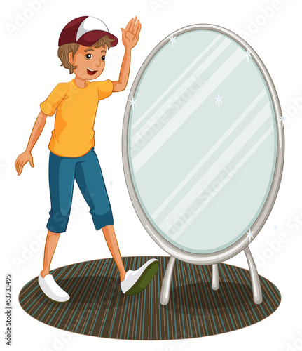 A boy beside a mirror