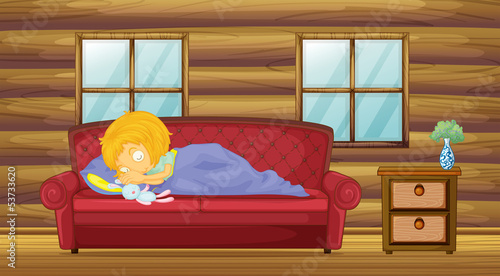 A girl sleeping at the sofa with a stuff toy