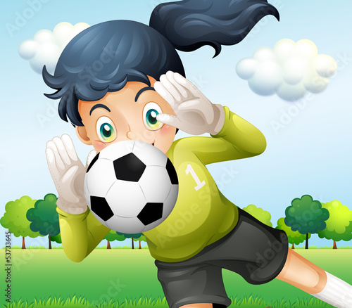 A girl catching a soccer ball