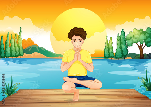 A young man exercising at the wooden bridge