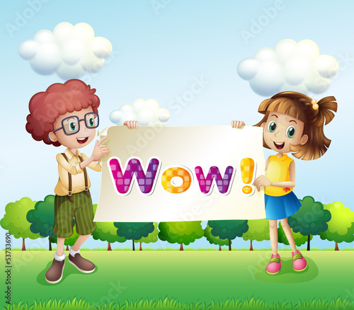 A boy and a girl holding a signage that has words on it