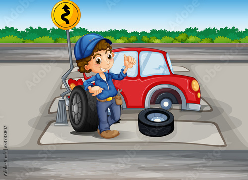 A boy repairing a car at the pedestrian lane