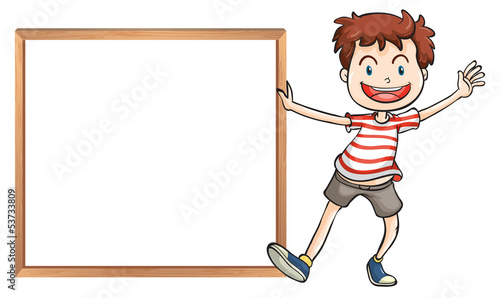 A young boy holding a framed signage