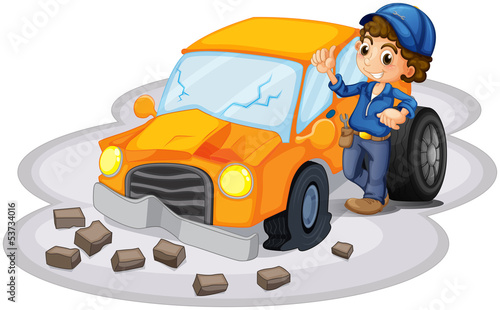 A boy fixing a broken orange car